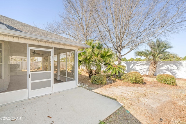 view of yard with a sunroom and fence