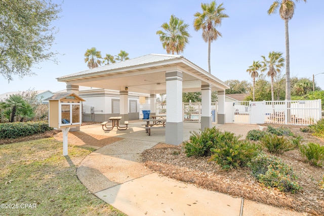 view of patio featuring a gate, fence, and a gazebo