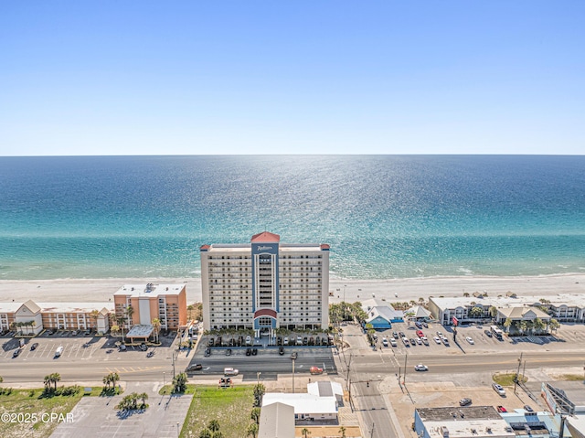 drone / aerial view with a beach view and a water view