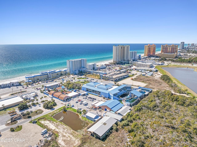 drone / aerial view featuring a view of city and a water view