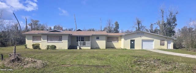 single story home with stucco siding, an attached garage, concrete driveway, and a front yard