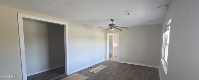 unfurnished room featuring ceiling fan, dark wood-type flooring, and baseboards