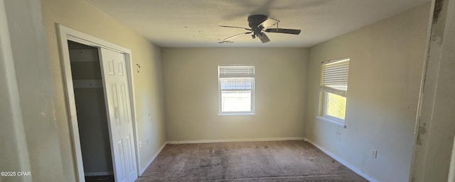 unfurnished bedroom with a closet, baseboards, a ceiling fan, and carpet flooring