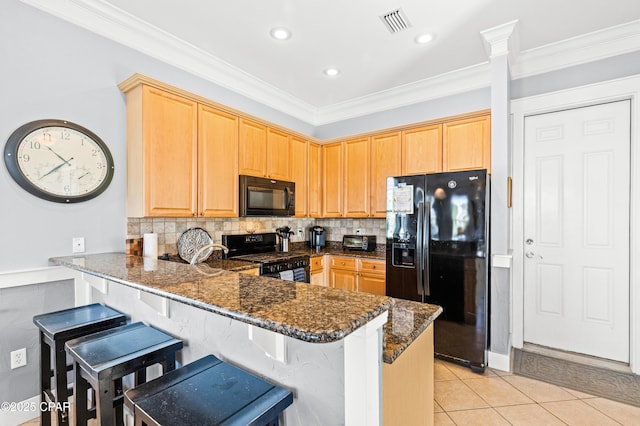 kitchen featuring a peninsula, black appliances, light tile patterned floors, and crown molding