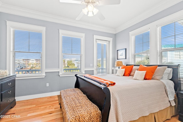 bedroom with light wood finished floors, ceiling fan, baseboards, and crown molding