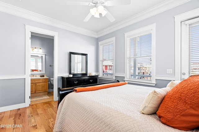 bedroom with connected bathroom, light wood-type flooring, crown molding, and ceiling fan