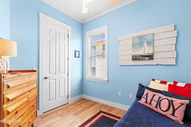 bedroom featuring crown molding, baseboards, and wood finished floors