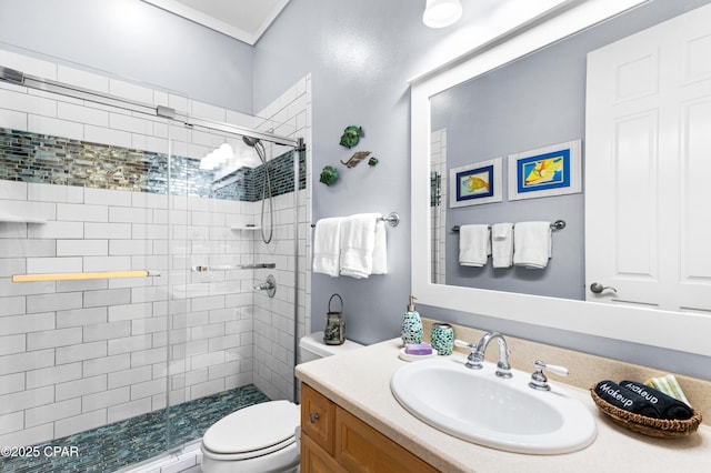 bathroom with a shower stall, toilet, and vanity