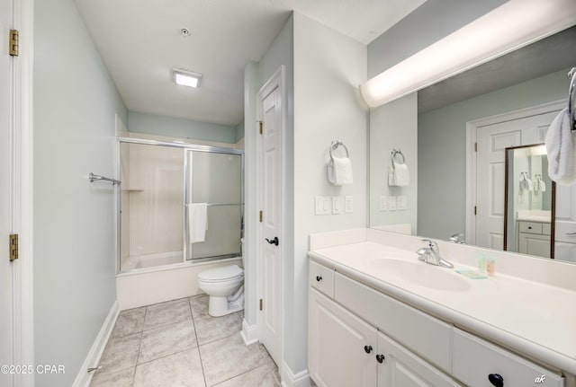 full bath featuring toilet, shower / bath combination with glass door, tile patterned flooring, baseboards, and vanity