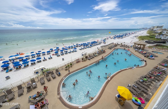 drone / aerial view with a water view and a beach view