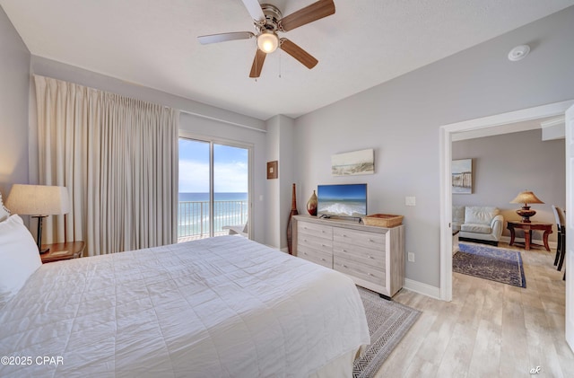 bedroom with baseboards, light wood-style floors, ceiling fan, and access to outside