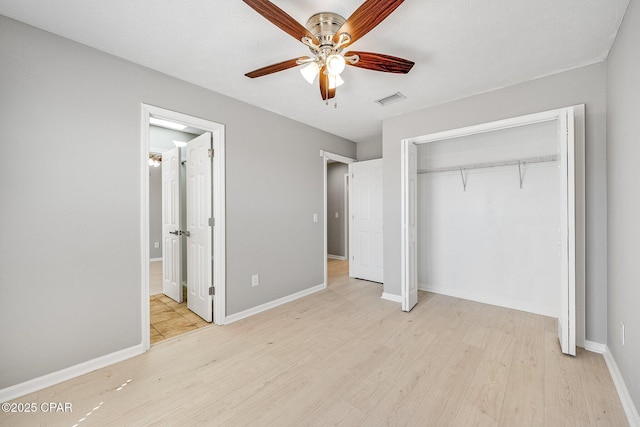 unfurnished bedroom featuring ensuite bathroom, visible vents, baseboards, a closet, and light wood finished floors