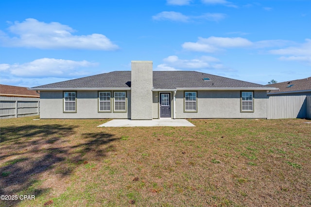 back of house featuring a lawn, a patio area, a fenced backyard, and stucco siding