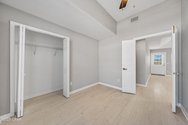 unfurnished bedroom with ceiling fan, visible vents, baseboards, light wood-style floors, and a closet