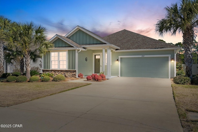 view of front of home with driveway, an attached garage, and board and batten siding