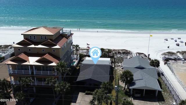 birds eye view of property featuring a beach view and a water view