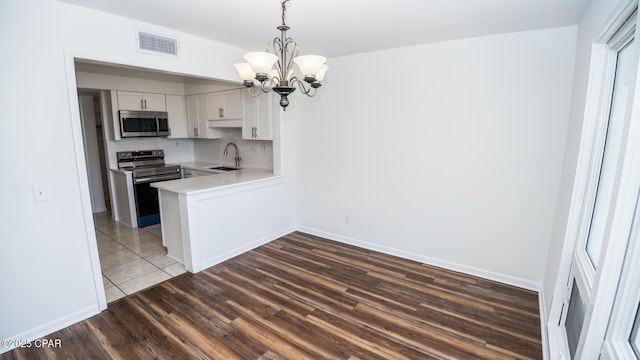 4305 Bay Point Rd Unit 459, Panama City, FL 32408 - kitchen featuring a notable chandelier, visible vents, a sink, light countertops, and appliances with stainless steel finishes