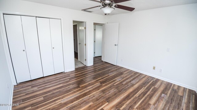 4305 Bay Point Rd Unit 459, Panama City, FL 32408 - unfurnished bedroom featuring a closet, a ceiling fan, wood finished floors, and baseboards