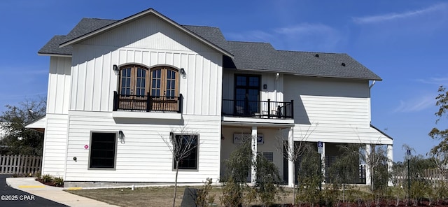 4305 Bay Point Rd Unit 459, Panama City, FL 32408 - view of front of home featuring board and batten siding, roof with shingles, fence, and a balcony