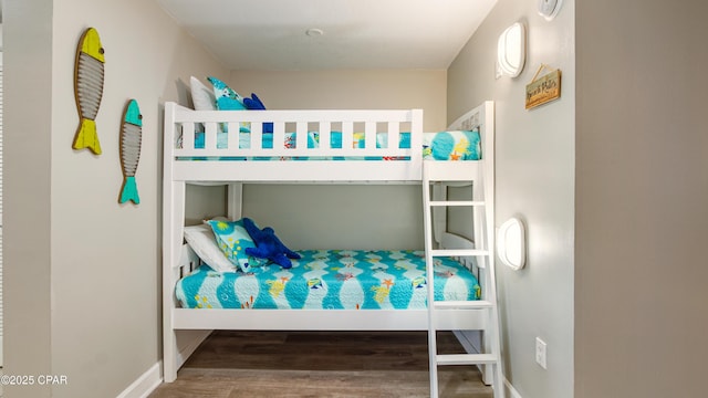 bedroom with wood finished floors and baseboards