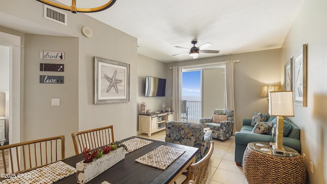 dining area with light tile patterned floors, visible vents, and a ceiling fan