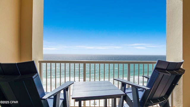 balcony with a water view and a beach view