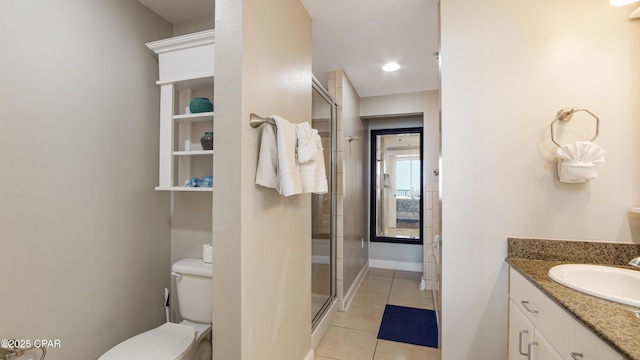 full bath with toilet, vanity, baseboards, tile patterned floors, and a stall shower