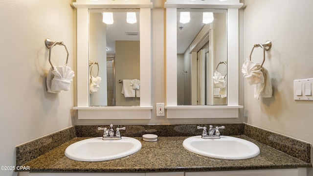 full bath with a sink and double vanity