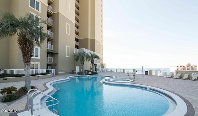 view of swimming pool featuring a community hot tub