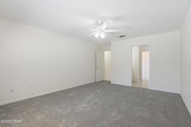 unfurnished bedroom with carpet floors, baseboards, visible vents, and ceiling fan