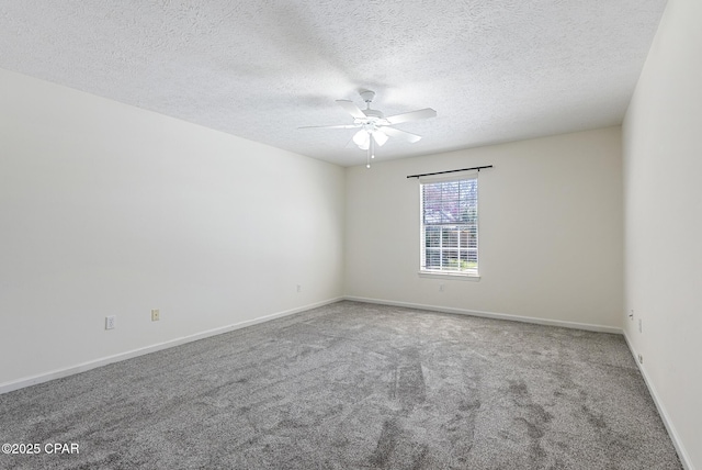 spare room with ceiling fan, carpet floors, a textured ceiling, and baseboards