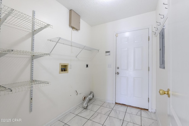 laundry area with washer hookup, electric dryer hookup, a textured ceiling, laundry area, and baseboards