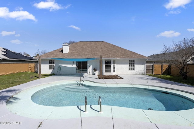 view of swimming pool with a patio area, fence, and a fenced in pool