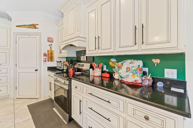 kitchen with light tile patterned flooring, electric range, custom range hood, and ornamental molding