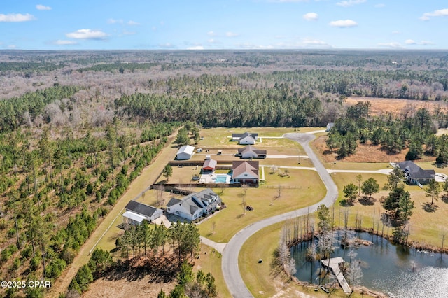 aerial view with a wooded view and a water view