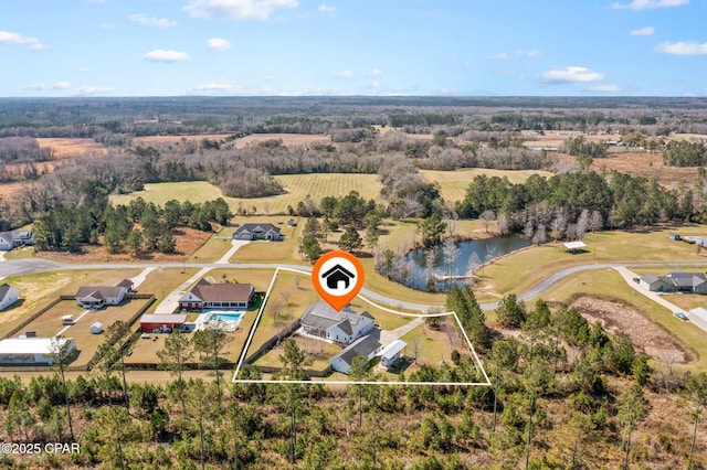 birds eye view of property featuring a water view and a rural view