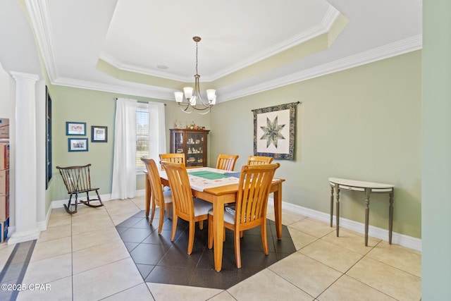 dining area with light tile patterned floors, a chandelier, a raised ceiling, and ornate columns