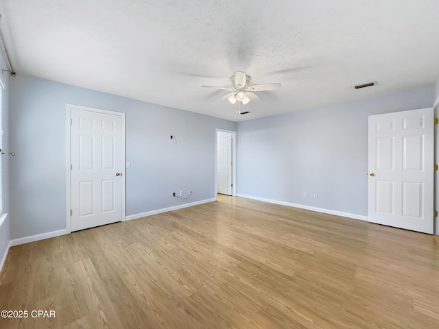 unfurnished room with visible vents, baseboards, ceiling fan, and light wood finished floors