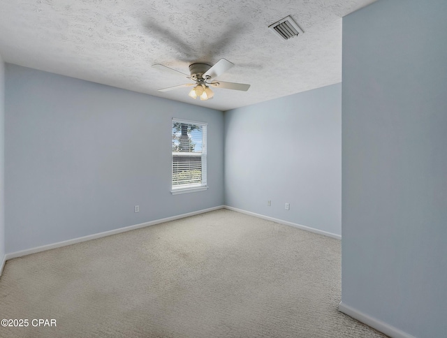 spare room with visible vents, carpet floors, and baseboards