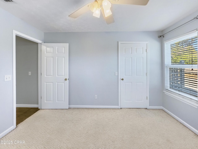 unfurnished bedroom with visible vents, ceiling fan, baseboards, and carpet floors