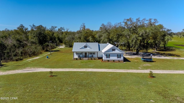 view of front facade featuring a front lawn, a trampoline, and covered porch