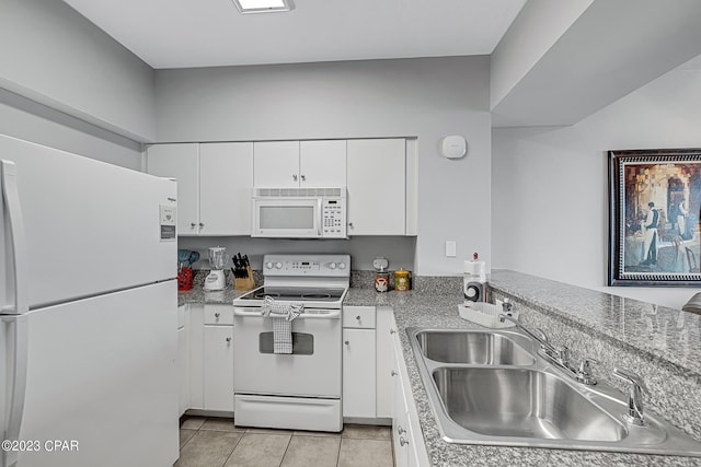 kitchen featuring light tile patterned floors, white appliances, a sink, white cabinets, and light countertops