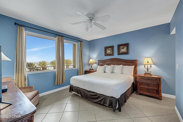 bedroom with ceiling fan, baseboards, and light tile patterned flooring