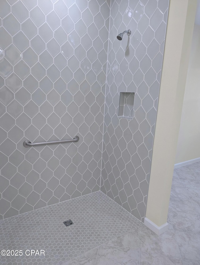 full bath with a tile shower