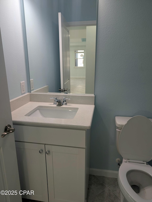 bathroom featuring toilet and vanity