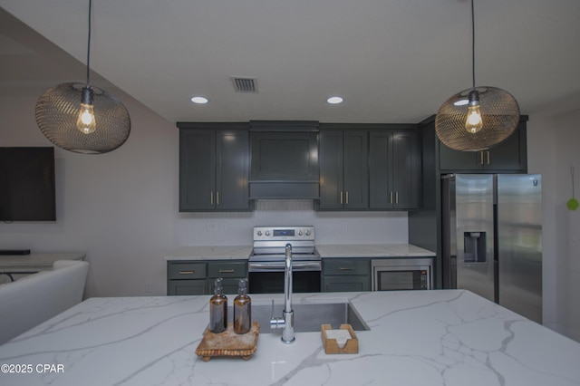 kitchen with decorative light fixtures, light stone counters, stainless steel appliances, and custom range hood