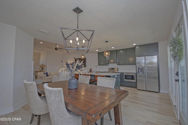 dining area featuring visible vents, baseboards, light wood-type flooring, recessed lighting, and a textured ceiling