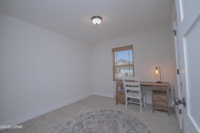 office featuring baseboards and light colored carpet