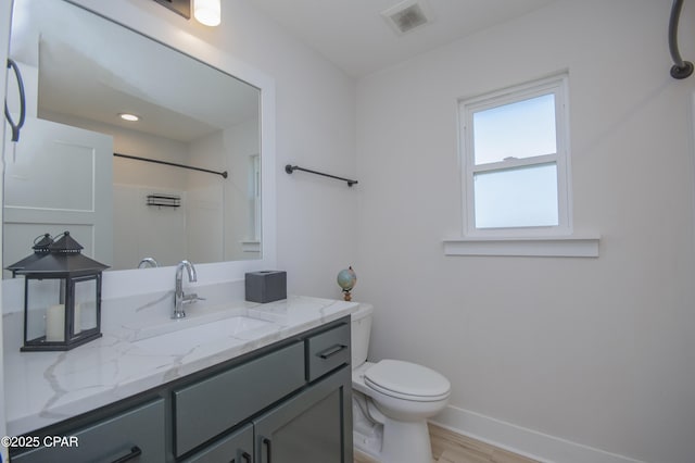 full bathroom featuring visible vents, toilet, wood finished floors, baseboards, and vanity