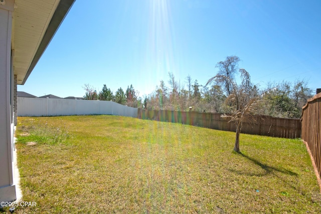 view of yard with a fenced backyard